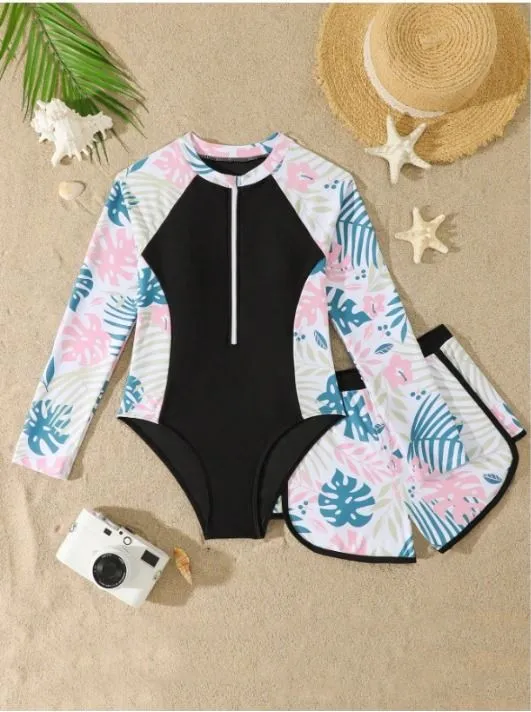 Traje de baño entero niñas, negro con estampado de hojas rosa y celeste en los costados